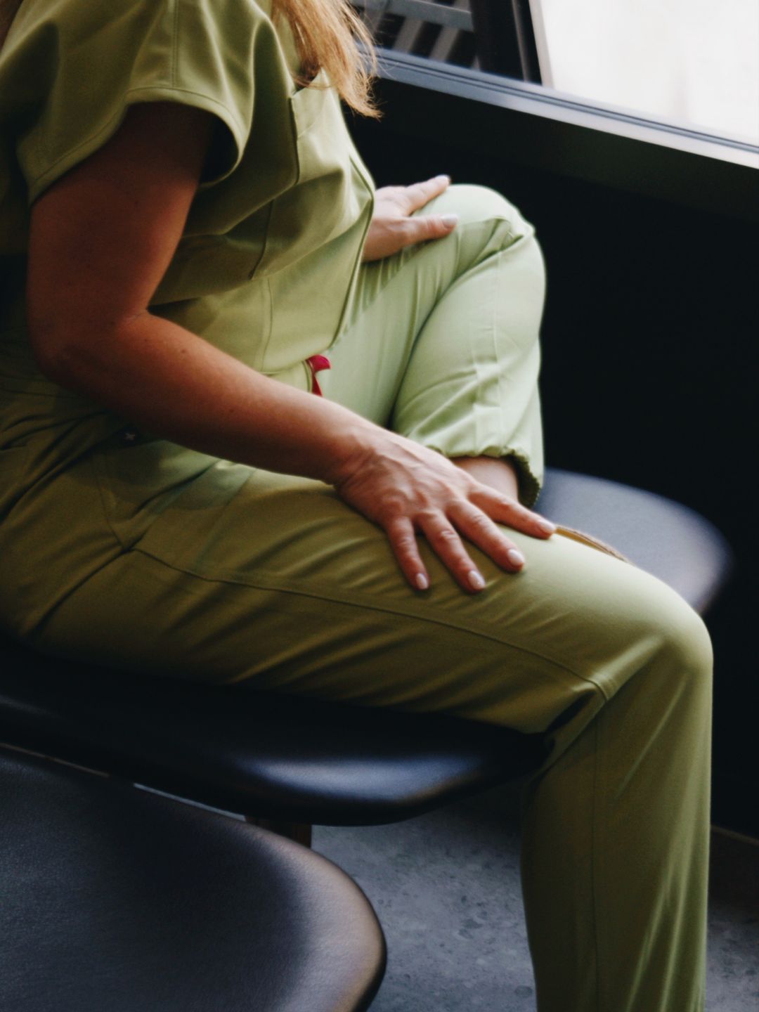 A practitioner in scrubs in the treatment room at Sian Aesthetics